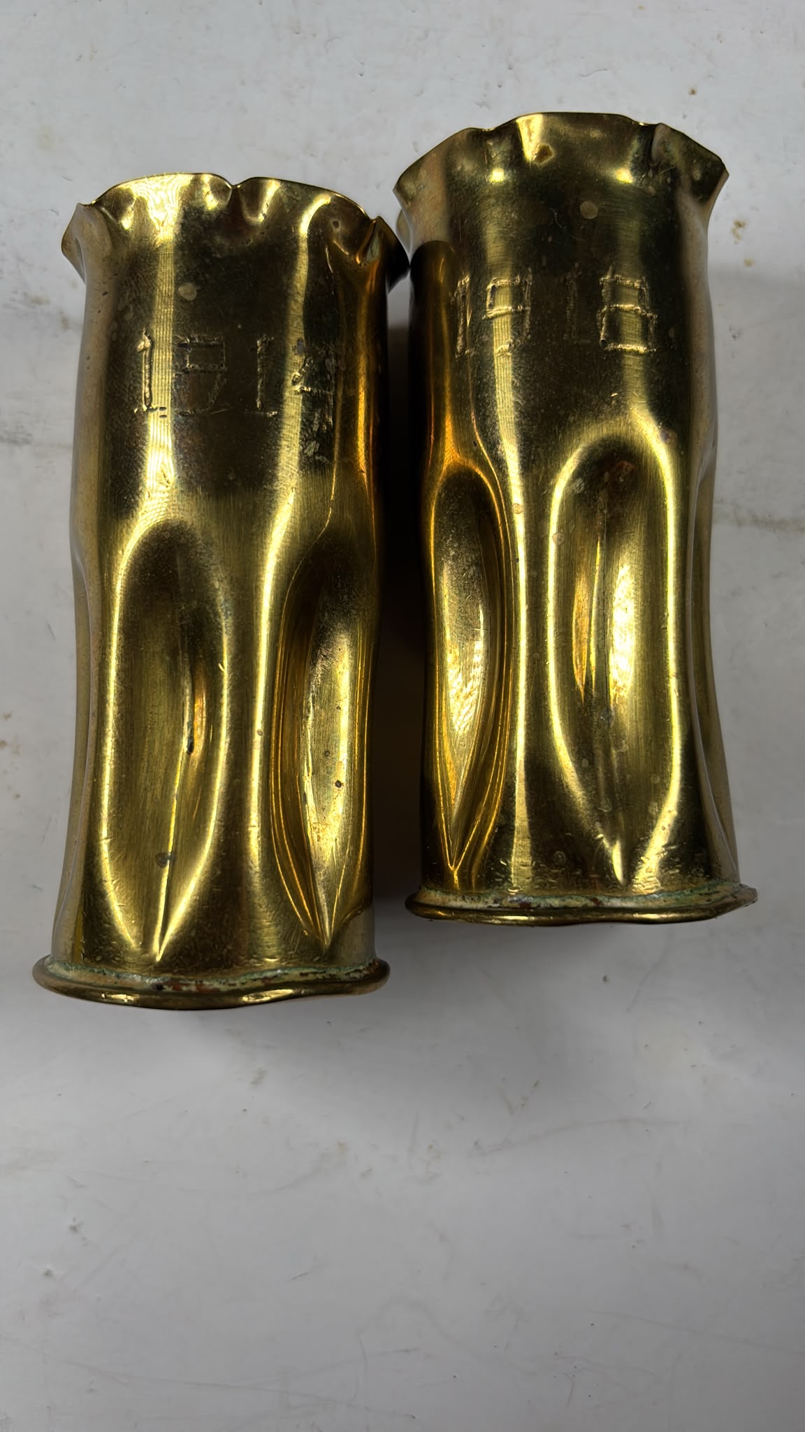 Image of A pair of brass bullet casings from WW1 dated 1914 and 1918