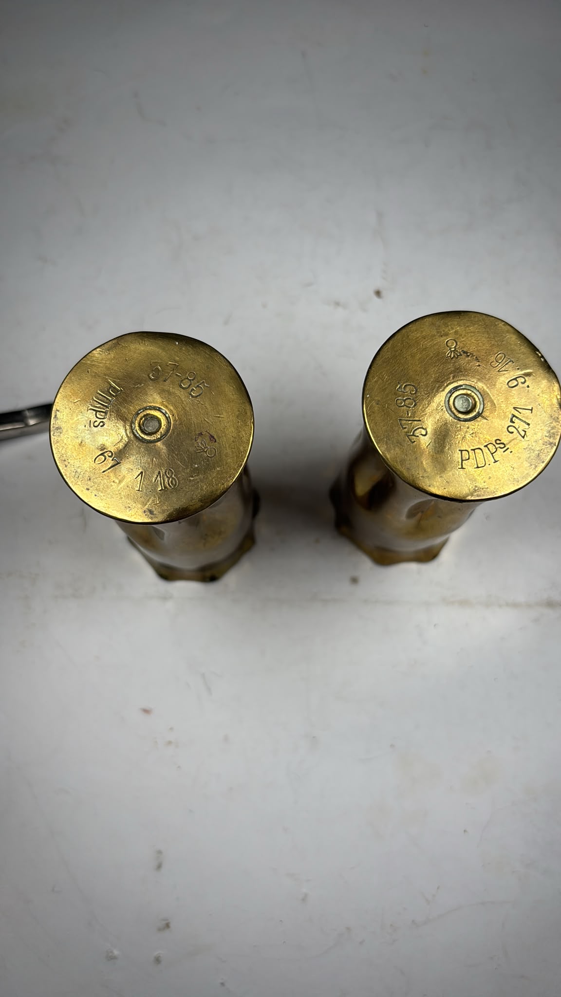 Image of A pair of brass bullet casings from WW1 dated 1914 and 1918