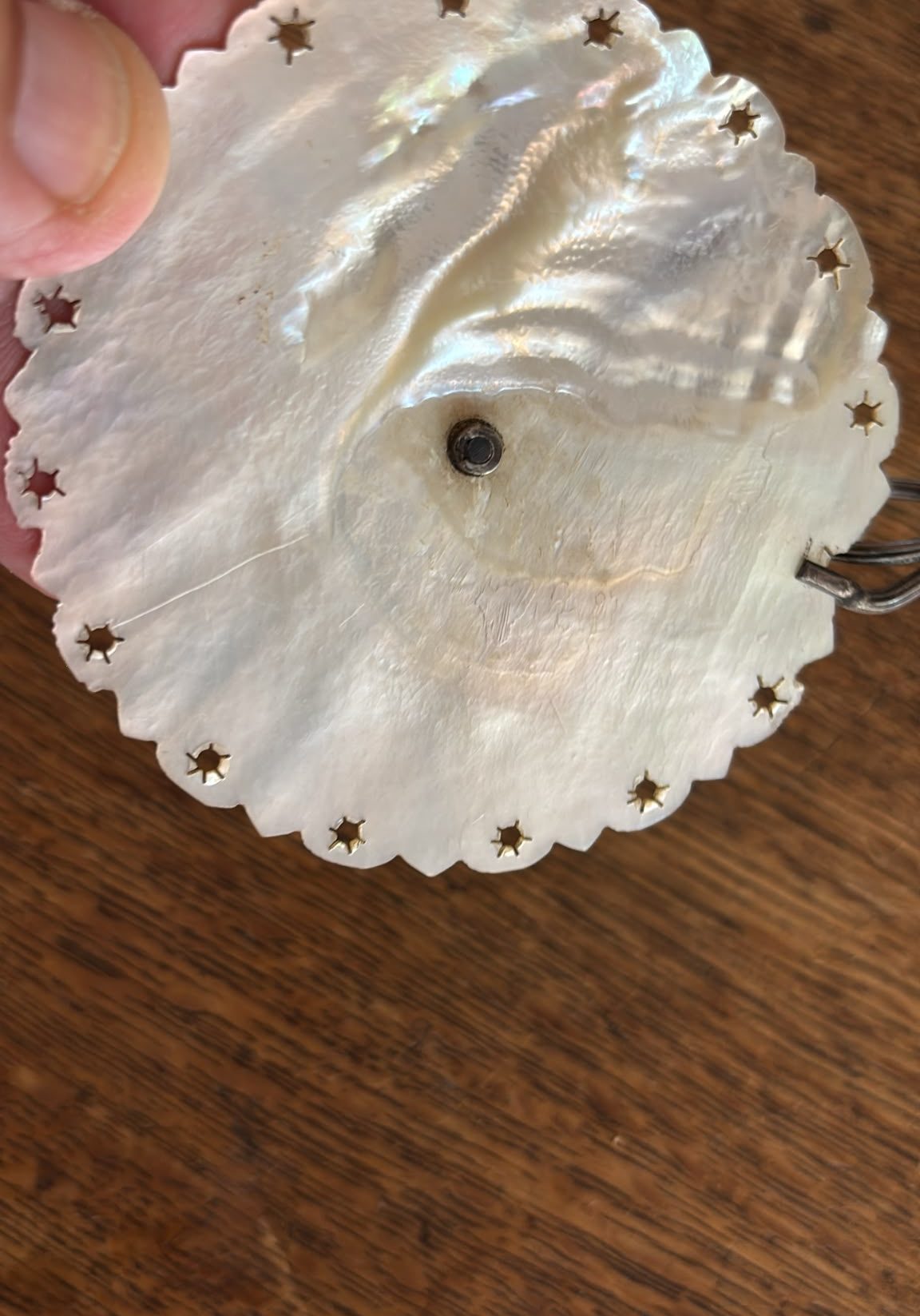 Image of underside of the Mother of pearl base with 3 silver branches. Very pretty