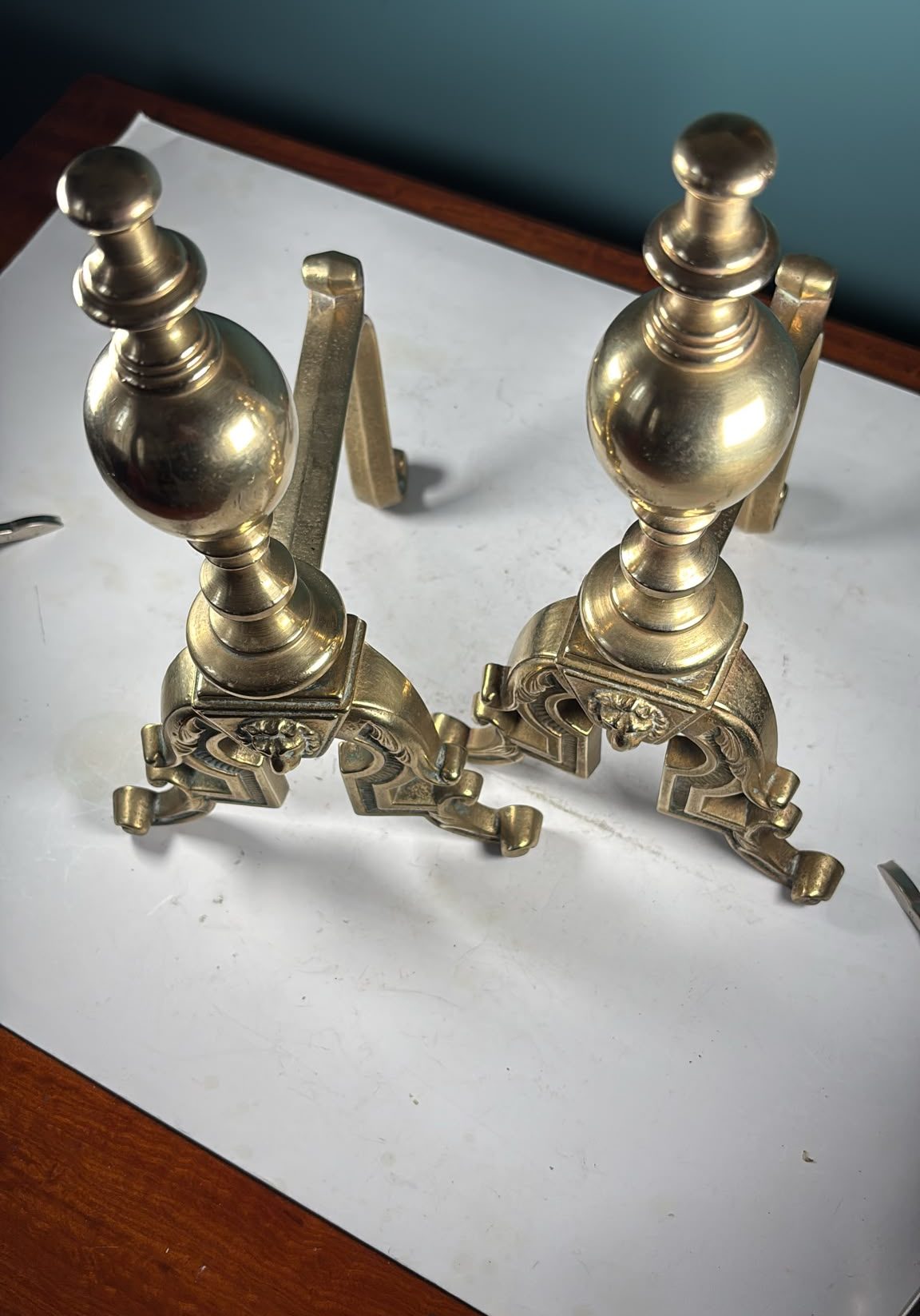 Image of A pair of Victorian, solid brass fire dogs with lions’ head decoration