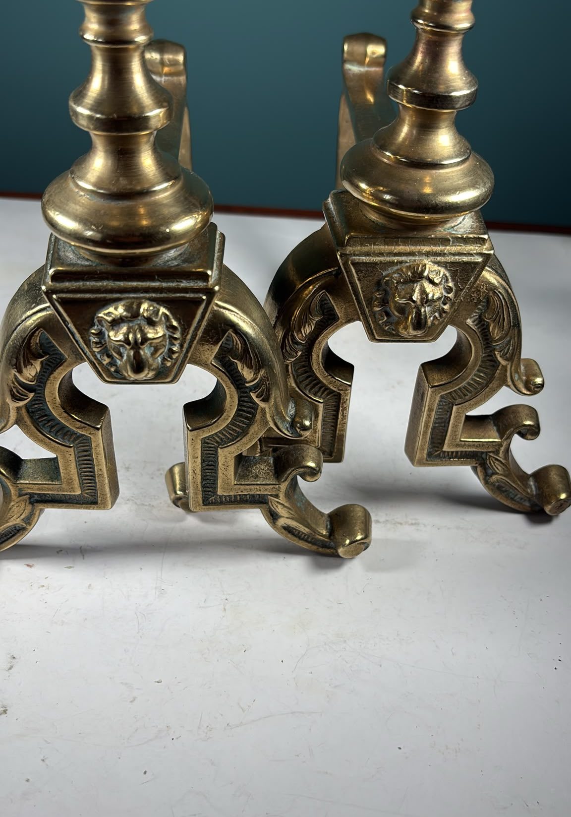 Image of A pair of Victorian, solid brass fire dogs with lions’ head decoration